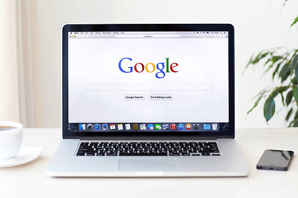 MacBook Pro Retina with Google home page on the screen Simferopol, Russia - August 7, 2014: Google biggest Internet search engine. Google.com domain was registered September 15, 1997. google stock pictures, royalty-free photos & images