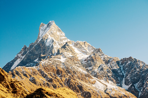 Machapuchare (6.993 m) is a mountain in the Annapurna Himalayas of north central Nepal. The peak is about 25 km north of Pokhara, the main town of the region.
Its double summit resembles the tail of a fish, hence the name meaning 
