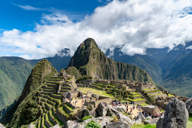 Machu Picchu in Peru Cusco, Peru - Oct 16, 2018: Machu Picchu aerial view. Tourists are walking through the old abandoned city. empire stock pictures, royalty-free photos & images