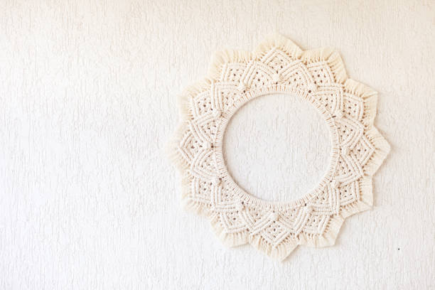 Macrame mandala. Macrame wreath on a white background close up. Natural cotton thread. Eco home decor. Copy space stock photo