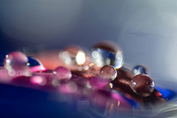 Macro, abstract composition with colorful water drops on a petal stock photo