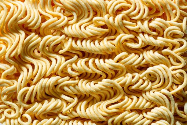 Macro instant raw noodle. Close-up uncooked ramen texture. Food background, top view  uncooked pasta stock pictures, royalty-free photos & images