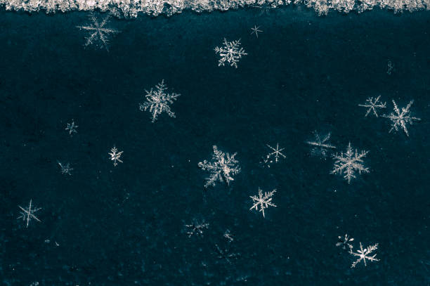 Macro of snowflakes on dark background stock photo