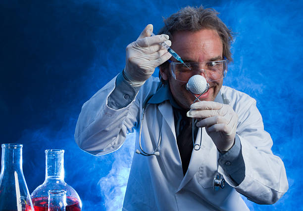 Mad Scientist with a Golf Ball and Hypodermic Needle stock photo