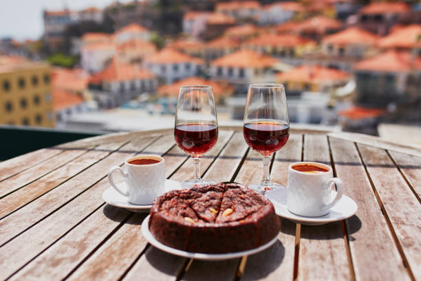 Madeira wine, coffee and hohey cake, View to Funchal, Portugal stock photo