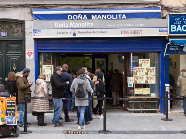 Madrid - Spanish Christmas Lottery tickets on sale at Dona Manolita lottery shop, people in line outside in Calle del Carmen. stock photo