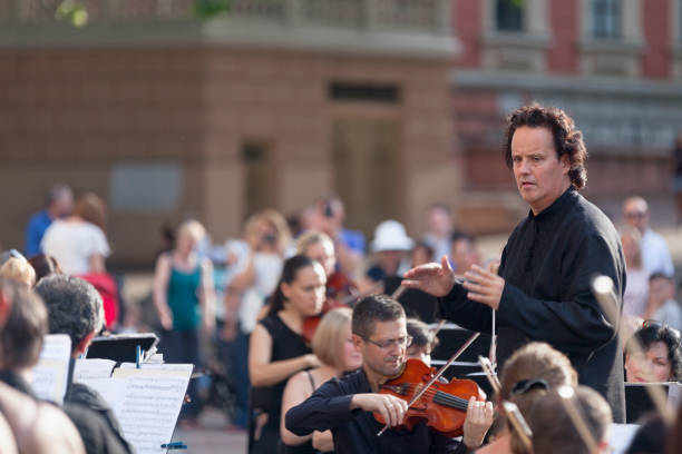 Maestro conducting his orchestra during a concert stock photo