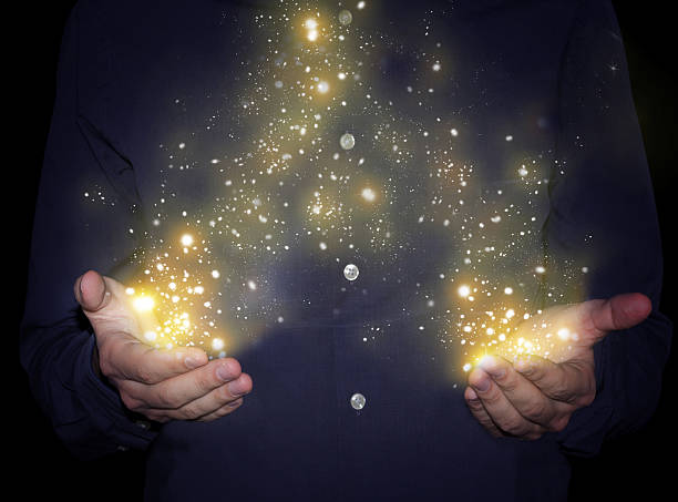 magic sparkles in hands stock photo