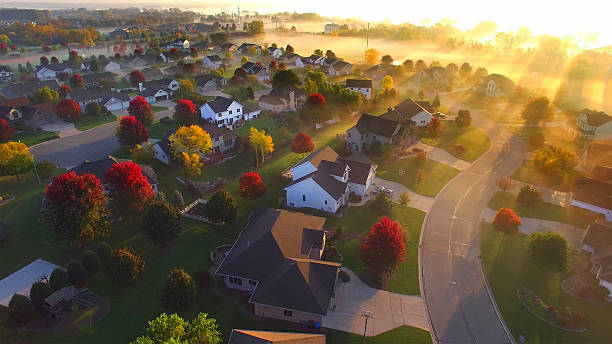 Magical sunrise over sleepy, foggy neighborhood Magical sunrise over sleepy neighborhood with shadows and sunbeams, through ground fog, aerial view. midwest usa stock pictures, royalty-free photos & images