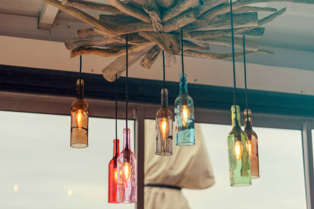 Magnificent retro light lamp decor made of colored wine bottles stock photo