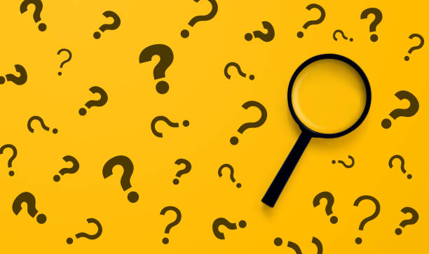 Magnifying glass and question mark sign on yellow background. Searching information data on internet networking concept stock photo