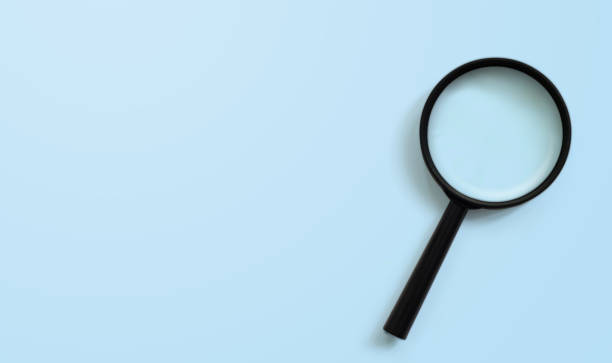 Magnifying glass on blue colour background with copy space. Searching information data concept Magnifying glass on blue colour background with copy space. Searching information data concept exploration stock pictures, royalty-free photos & images