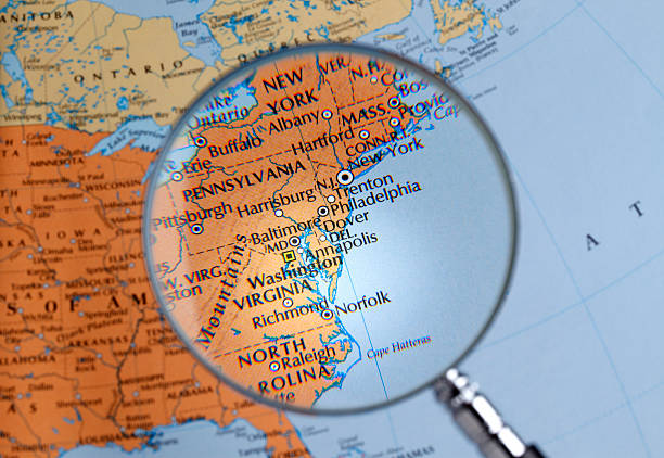 Magnifying glass over a map of East Coast close up of East Coast thru a magnifying glass eastern usa stock pictures, royalty-free photos & images