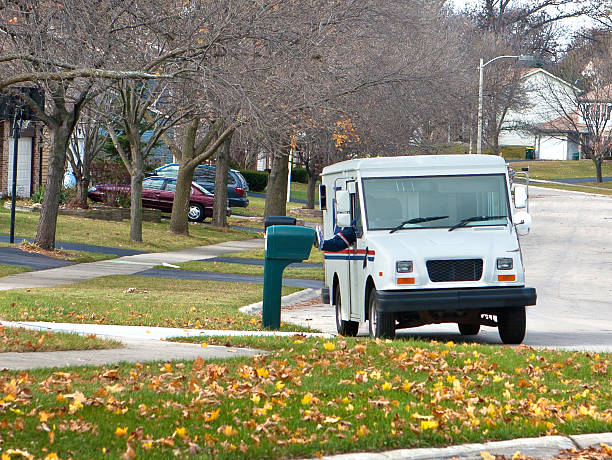mail truck in the suburbs stock photo