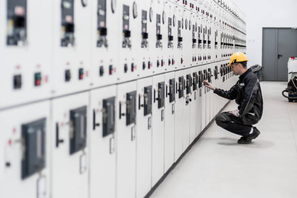 Maintenance engineer testing voltage switchgear and bay control unit Maintenance engineer testing medium voltage switchgear and bay control unit. Relay protection system high voltage sign photos stock pictures, royalty-free photos & images