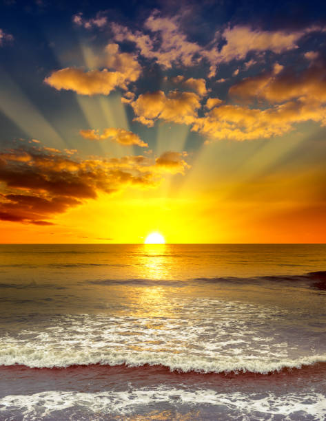 Majestic bright sunrise over the ocean. Majestic bright sunrise over the ocean. Calm sea and orange clouds. sunrise dawn stock pictures, royalty-free photos & images