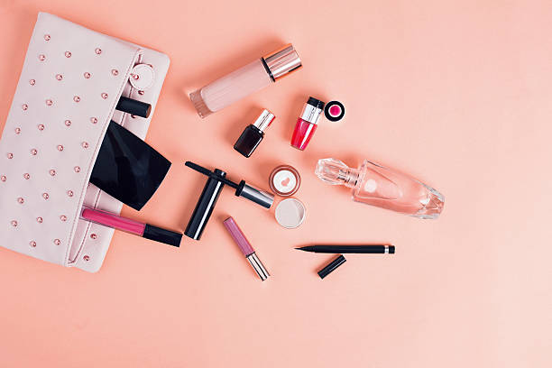 Make up bag with cosmetics isolated on pink background stock photo