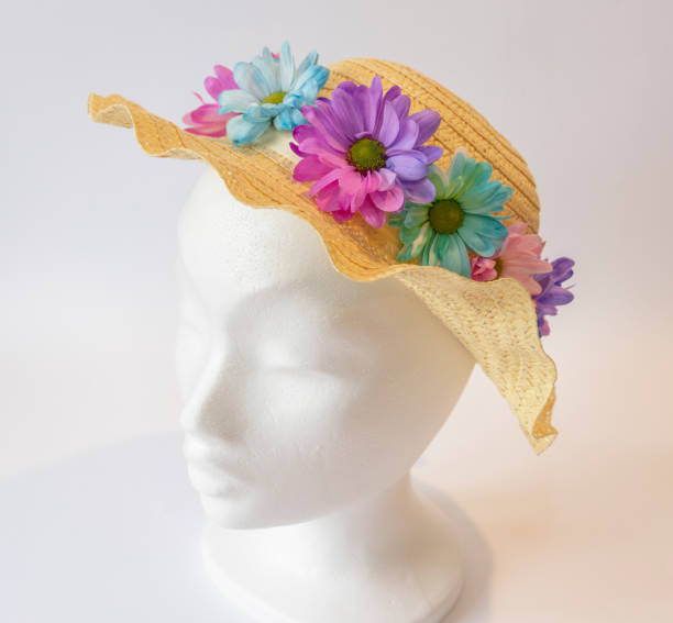 Make Your Own Easter Bonnet with Fresh Flowers Straw hat is decorated with fresh flowers on a plain background easter sunday stock pictures, royalty-free photos & images