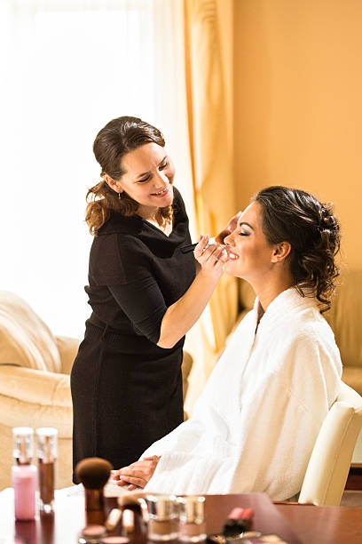 Make-up artist applying makeup stock photo
