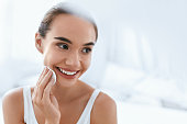 Makeup Remove. Beautiful Girl Cleaning Face Skin With White Cosmetic Pad. High Resolution