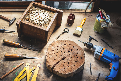 Making wooden insect hotel or house in workshop