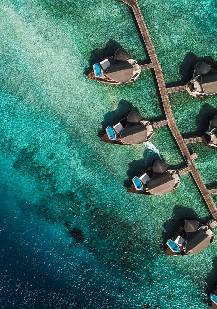 maldives island lagoon with water villas - maya bay imagens e fotografias de stock