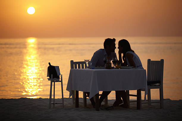 maldivian silhouette - sunset dining stockfoto's en -beelden