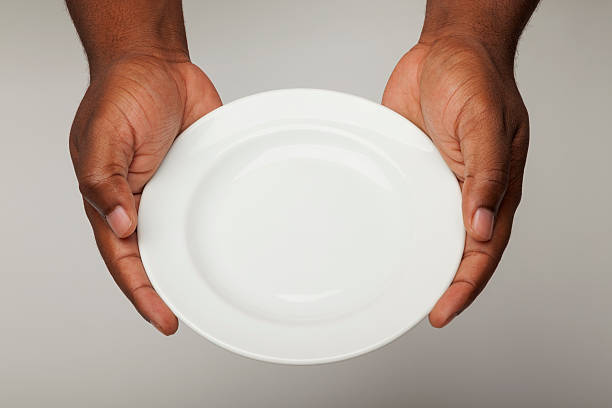 Male African American hands holding an empty plate stock photo