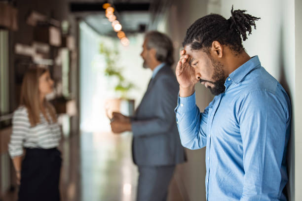 Male African American office worker reacts negatively to bad news. stock photo