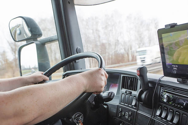 Male arms driving a truck on the road stock photo