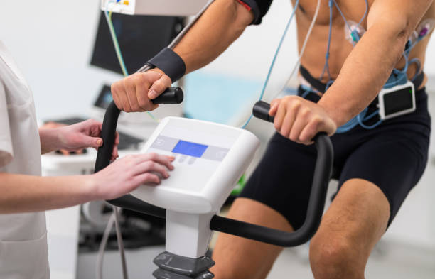 Male Athlete Performing ECG And VO2 Test On Indoor Bicycle stock photo