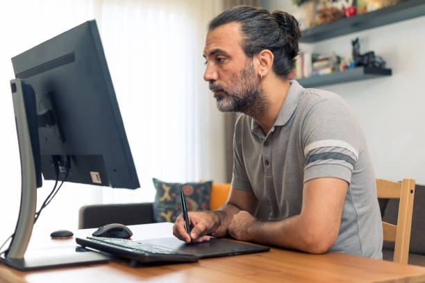 Male digital artist working at home stock photo
