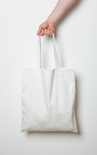 Male Hand Holding White Textile Bag Stock Photo - Download Image Now ...