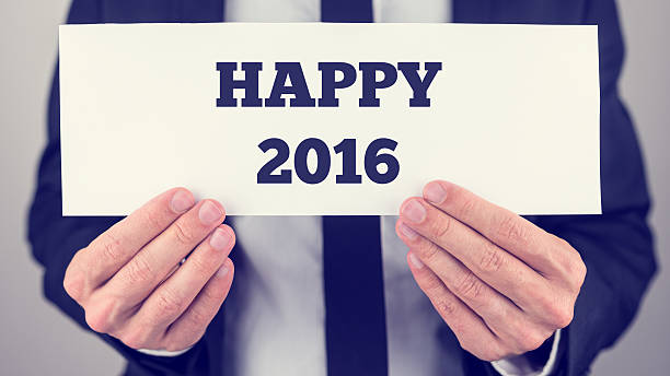 Male hands holding a white banner with Happy 2016 sign Closeup of male hands holding a white banner with Happy 2016 sign. happy new year card 2016 stock pictures, royalty-free photos & images