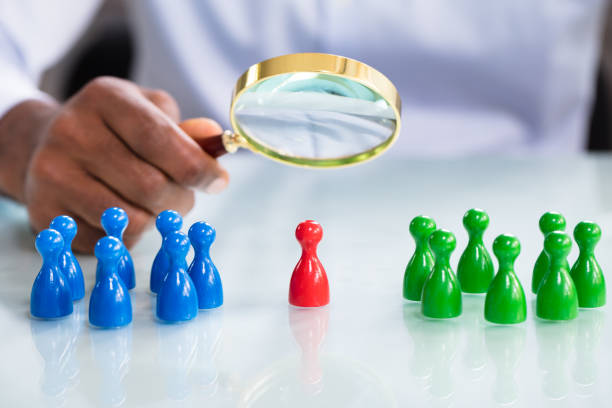 Male Looking At Colorful Pawns With Magnifying Glass A Male Looking At Colorful Pawns With Magnifying Glass On The Reflective Desk midsection stock pictures, royalty-free photos & images