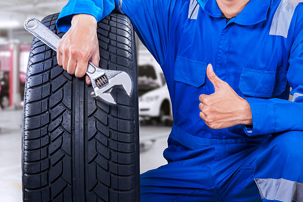 Male mechanic showing thumb up in workshop stock photo