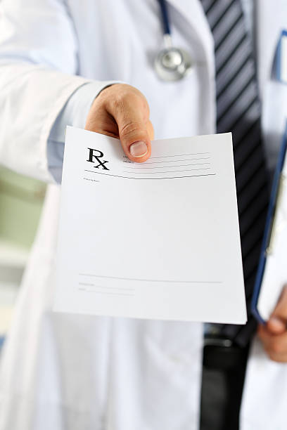 Male medicine doctor hand hold clipboard pad and give prescripti Male medicine doctor hand hold clipboard pad and give prescription to patient closeup. Panacea and life save, prescribe treatment, legal drug store, contraception concept. Empty form ready to be used human limb photos stock pictures, royalty-free photos & images