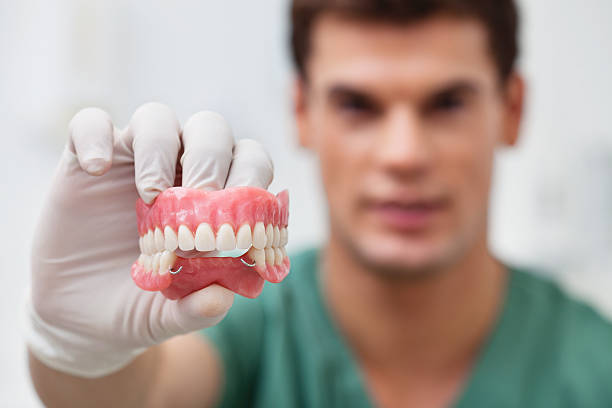 Male practitioner holding dental mold stock photo