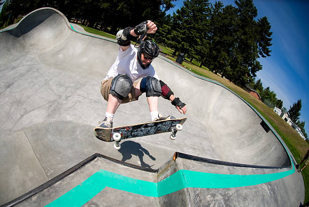 Male Skateboarder in Skate Park on Sunny Day stock photo