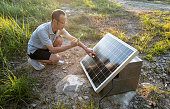 istock Male technician using mobile phone to take photos of solar panels 1330068902