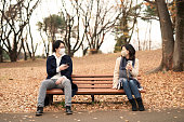 istock Man and woman with smart phone talking in keeping social distance 1291872076