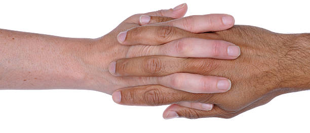 Man and Woman's Hands with Fingers Intertwined stock photo