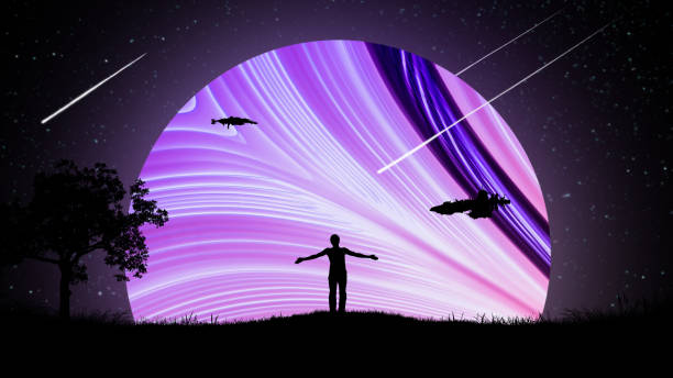 A man at night outdoors with his hands apart, raised to the air against the background of the starry sky with spaceships and a beautiful glowing neon planet. stock photo