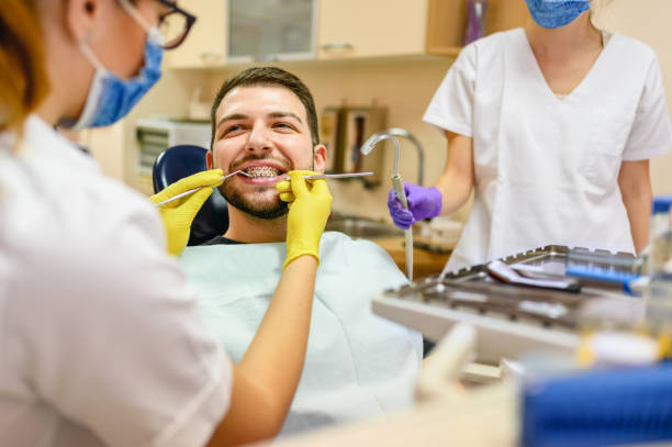 Man at the dentist braces check up stock photo