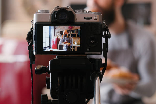 man bakery business culinary vlog podcast camera Bakery business. Culinary vlog. Podcast shooting. Man in apron with fresh pastries. Camera screen. french food photos stock pictures, royalty-free photos & images