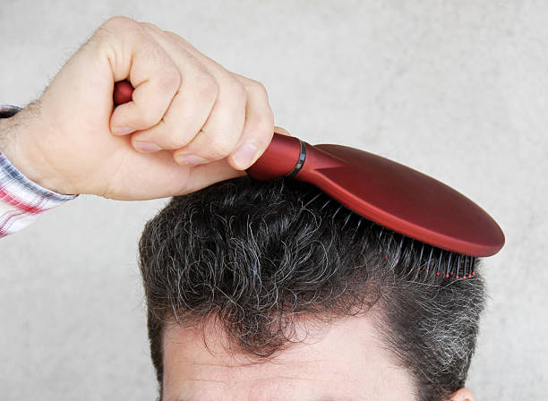 Man brushing hair stock photo