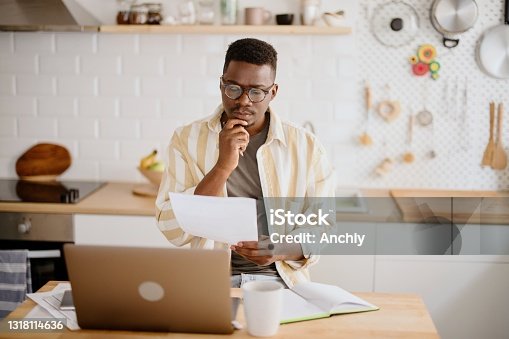 istock Man calculates personal income by using laptop and online banking on smartphone 1318114636