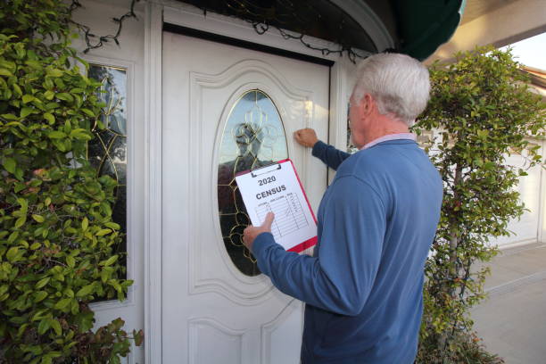 Man Canvassing Door to Door for the 2020 Census A man going door to door collecting information for the 2020 census. census stock pictures, royalty-free photos & images