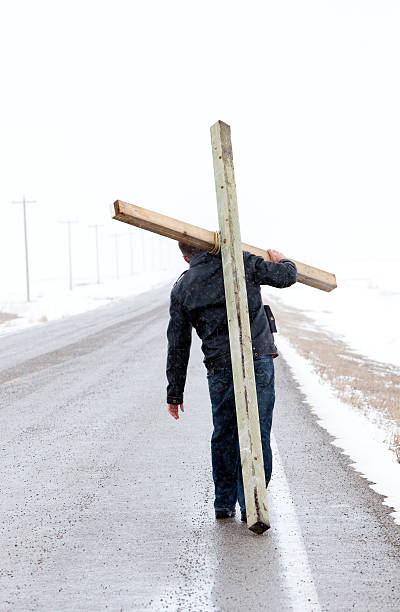 Man Carrying a Cross at Easter  good friday stock pictures, royalty-free photos & images