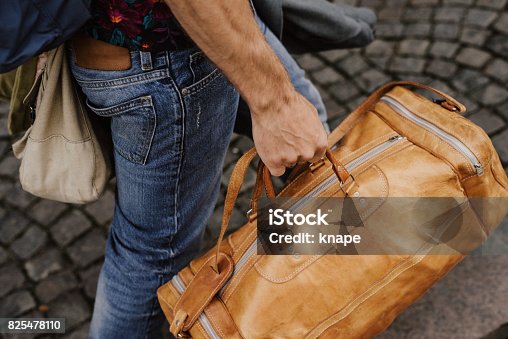 istock Man carrying bags and luggage 825478110